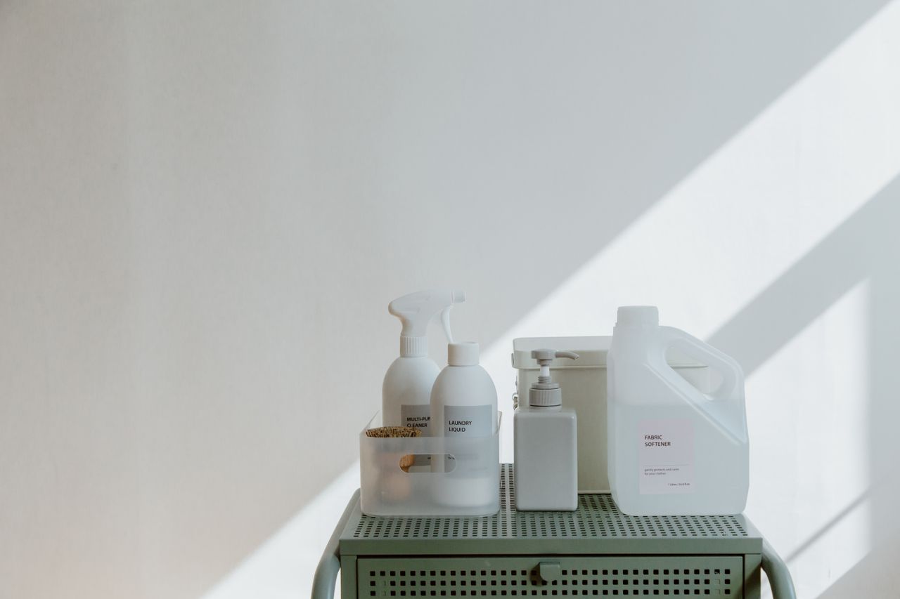 About Aesthetic arrangement of cleaning products in minimalistic containers with soft shadow play.
